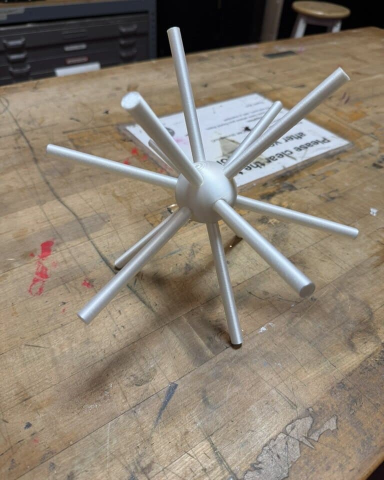 Where it started: the first white print of the icosahedron hub with stems, alone on the workbench