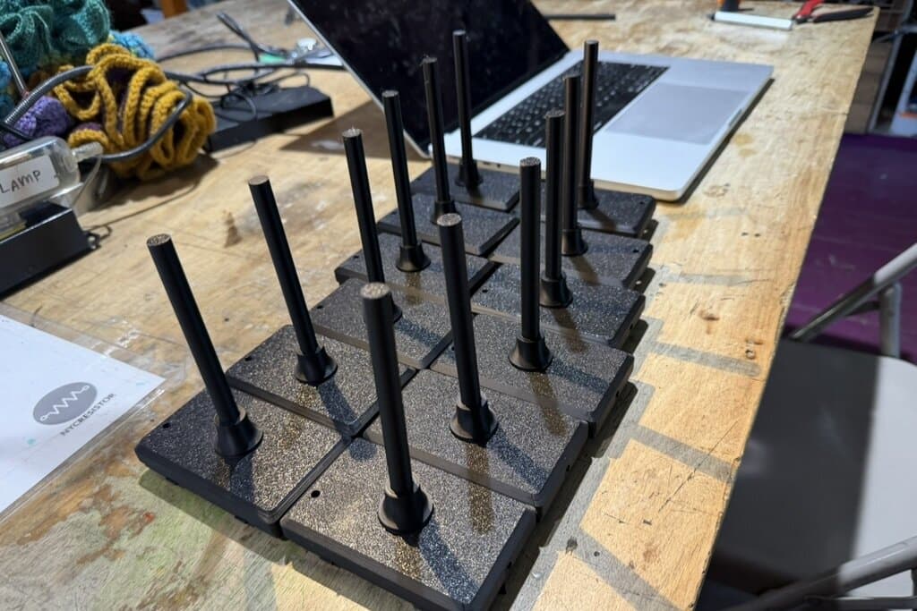 A batch of case bases with stems installed, standing upright on the workbench