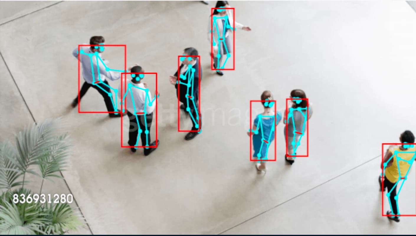 Overhead view of people walking in a public space with data drawn on top