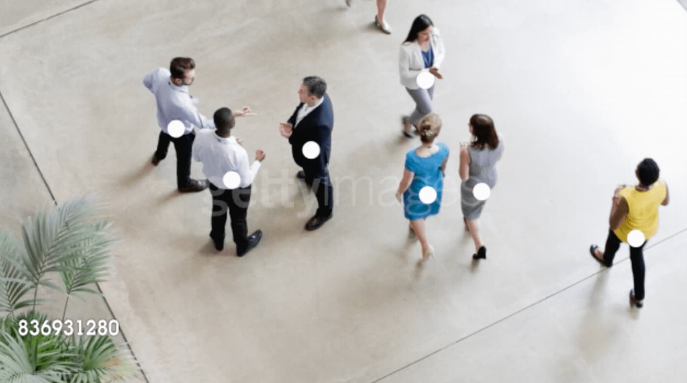 Overhead view of people walking in a public space with data drawn on top